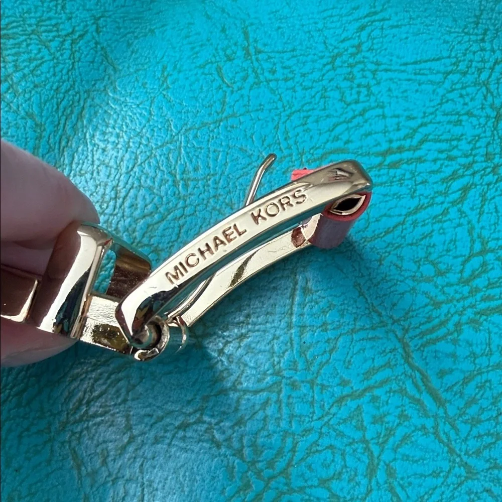 Reversible Michael Kors MK logo belt with bright shiny coral side - see flaw